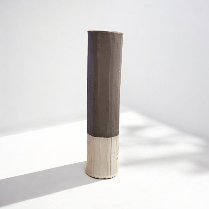 Black stoneware sculpted vase, glazed on the bottom with a white matt glaze.